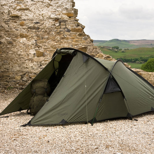 Snugpak Scorpion 3 IX olive green three-person tent set up outdoors showing angled profile and front porch area