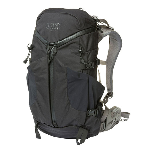 Mystery Ranch Coulee 25 backpack showing 3-ZIP design and external stretch pockets for hiking gear